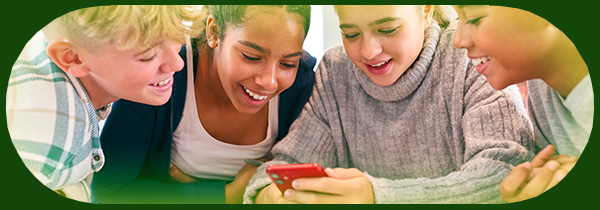 Children laughing while looking at a phone
