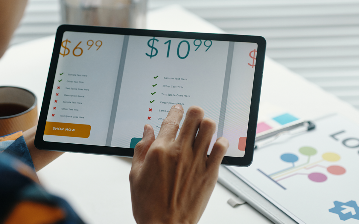 A parent comparing learning program prices on a tablet